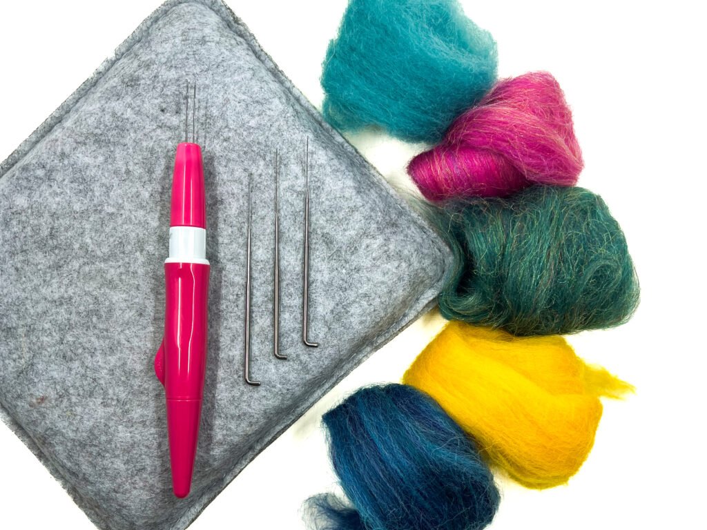 To start needle felting, you need a felting mat, specialized barbed felting needles and some wool