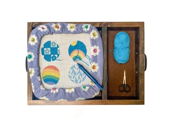 Punch needle frame with colorful cover in a punch needle lap tray