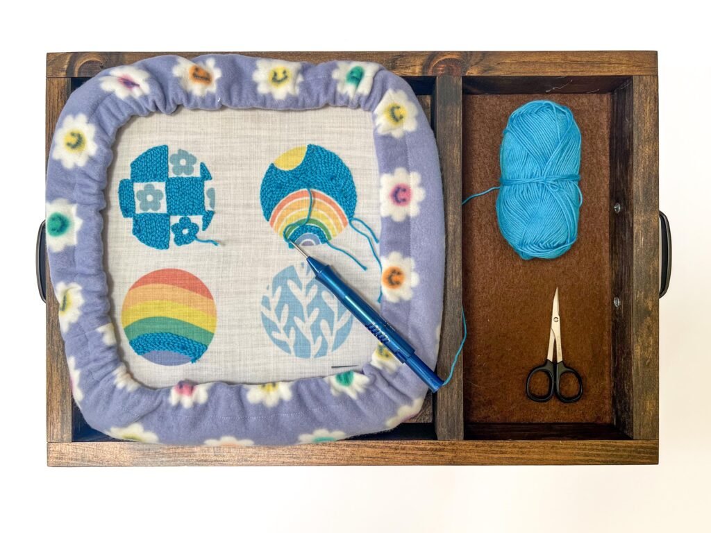 punch needle embroidery set up with punch needle frame and cover, lap tray and project displaying punch needle rug mug creation